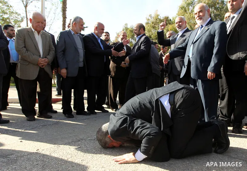 Hamas chief Khaled Meshaal prays, with his head to the ground, upon his arrival in Rafah, southern Gaza, on December 7, 2012. Meshaal is making his first-ever visit to the Gaza Strip amid tight security for festivities m...