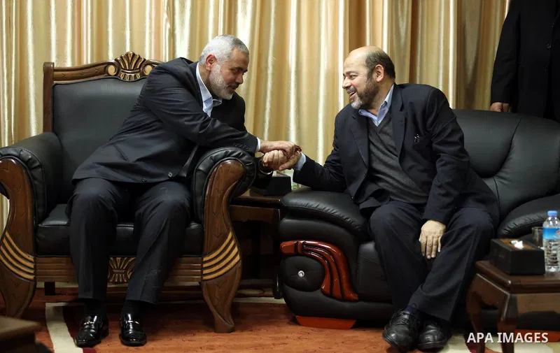 Palestinian prime minister in Gaza Strip Ismail Haniyeh shakes hands with Moussa Abu Marzouk upon his arrival in Rafah, southern Gaza, on December 7, 2012. Marzouk is making his first-ever visit to the Gaza Strip amid ti...