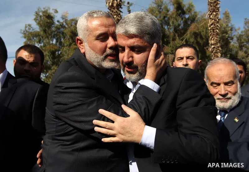 Hamas prime minister Ismail Haniya shows Haniya (L) greeting Palestinian Hamas leader in exile Khaled Meshaal upon the latter's arrival in the Gaza Strip from the Rafah border crossing on December 7, 2012. Meshaal made h...