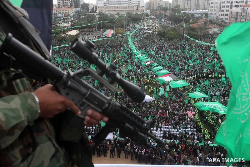 A member of Hamas stands guard during rally marking the 25th anniversary of the Islamist movement's founding in Gaza City on December 8, 2012. Hamas chief Khaled Meshaal arrived to Gaza strip on December 7 during his fir...