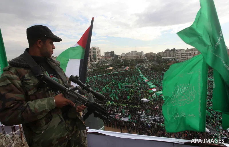 A member of Hamas stands guard during rally marking the 25th anniversary of the Islamist movement's founding in Gaza City on December 8, 2012. Hamas chief Khaled Meshaal arrived to Gaza strip on December 7 during his fir...
