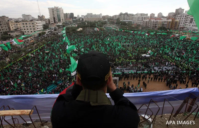 A member of Hamas stands guard during rally marking the 25th anniversary of the Islamist movement's founding in Gaza City on December 8, 2012. Hamas chief Khaled Meshaal arrived to Gaza strip on December 7 during his fir...