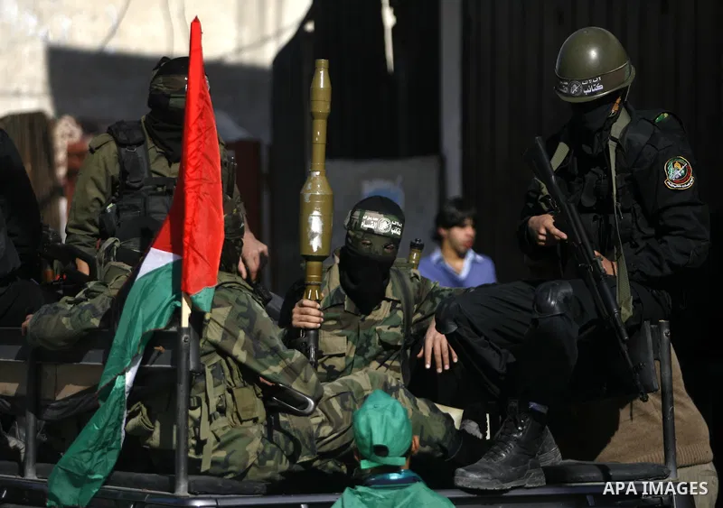 Masked Hamas security men stand guard during a Hamas rally marking the 25th anniversary of the Islamist movement's founding in Gaza City on December 8, 2012. Hamas chief Khaled Meshaal arrived to Gaza strip on December 7...