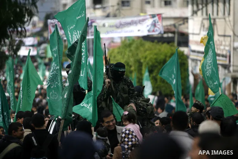 Masked Hamas security men stand guard during a Hamas rally marking the 25th anniversary of the Islamist movement's founding in Gaza City on December 8, 2012. Hamas chief Khaled Meshaal arrived to Gaza strip on December 7...