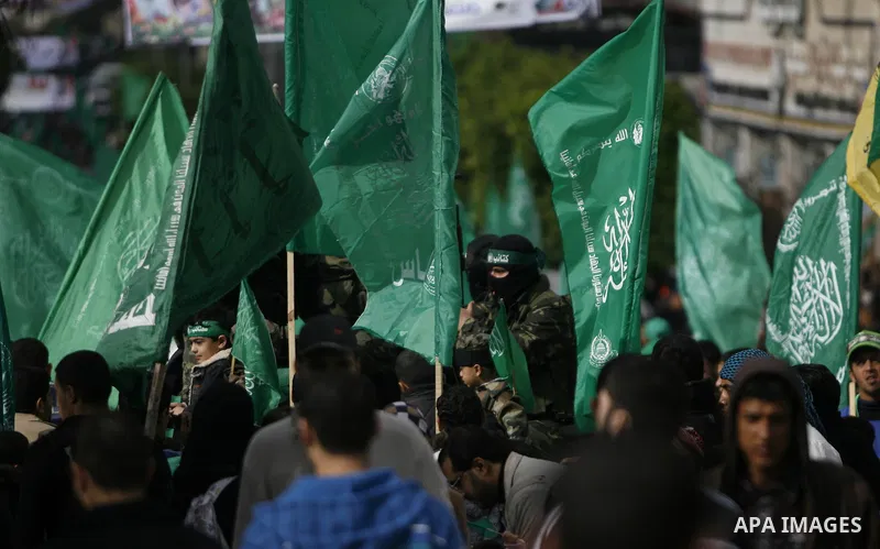 Masked Hamas security men stand guard during a Hamas rally marking the 25th anniversary of the Islamist movement's founding in Gaza City on December 8, 2012. Hamas chief Khaled Meshaal arrived to Gaza strip on December 7...