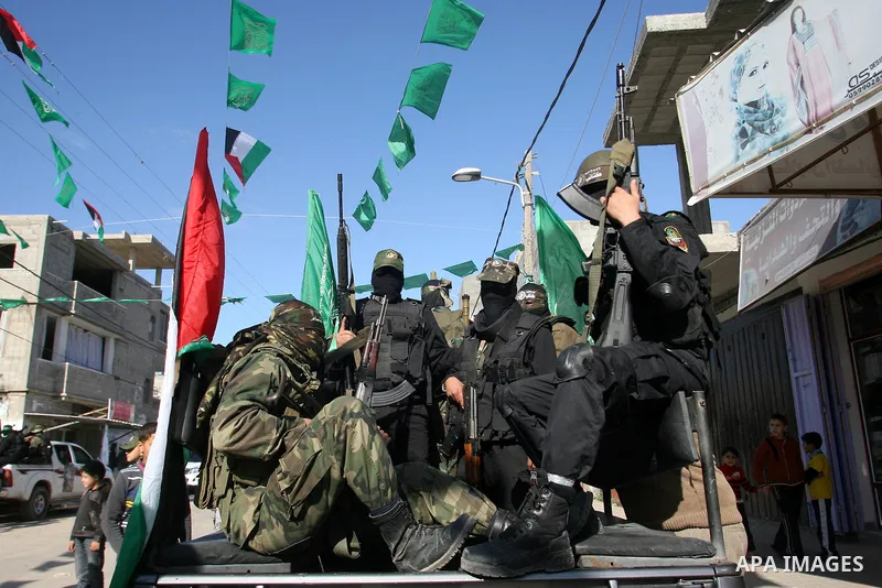 Masked Hamas security men stand guard during a Hamas rally marking the 25th anniversary of the Islamist movement's founding in Gaza City on December 8, 2012. Hamas chief Khaled Meshaal arrived to Gaza strip on December 7...