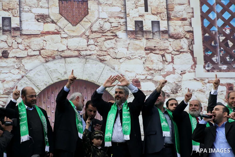 Hamas chief Khaled Meshaal, with senior Hamas leaders, takes part in a Hamas rally marking the 25th anniversary of the Islamist movement's founding in Gaza City on December 8, 2012. Meshaal arrived to Gaza strip on Decem...