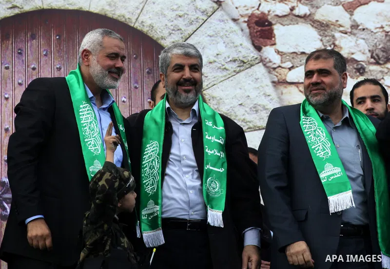 Hamas chief Khaled Meshaal, with senior Hamas leaders, takes part in a Hamas rally marking the 25th anniversary of the Islamist movement's founding in Gaza City on December 8, 2012. Meshaal arrived to Gaza strip on Decem...