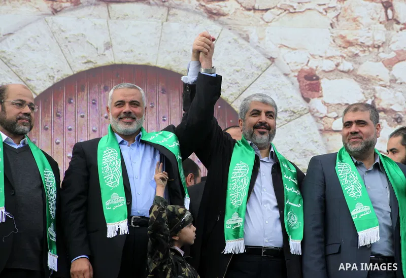 Hamas chief Khaled Meshaal, with senior Hamas leaders, takes part in a Hamas rally marking the 25th anniversary of the Islamist movement's founding in Gaza City on December 8, 2012. Meshaal arrived to Gaza strip on Decem...