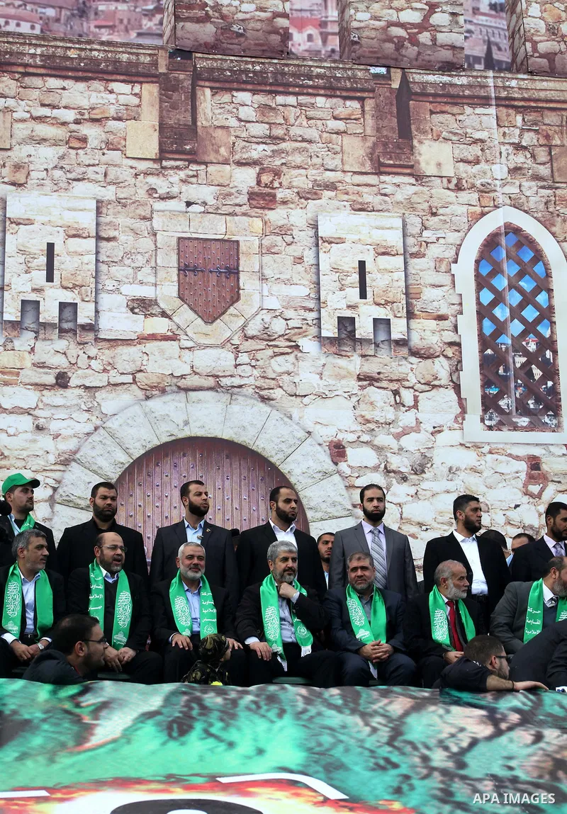 Hamas chief Khaled Meshaal, with senior Hamas leaders, takes part in a Hamas rally marking the 25th anniversary of the Islamist movement's founding in Gaza City on December 8, 2012. Meshaal arrived to Gaza strip on Decem...