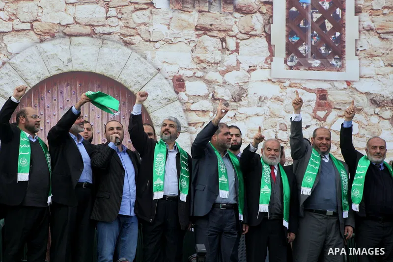 Hamas chief Khaled Meshaal, with senior Hamas leaders, takes part in a Hamas rally marking the 25th anniversary of the Islamist movement's founding in Gaza City on December 8, 2012. Meshaal arrived to Gaza strip on Decem...