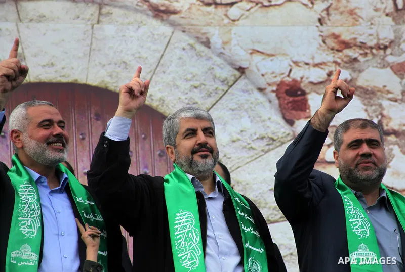 Hamas chief Khaled Meshaal, with senior Hamas leaders, takes part in a Hamas rally marking the 25th anniversary of the Islamist movement's founding in Gaza City on December 8, 2012. Meshaal arrived to Gaza strip on Decem...
