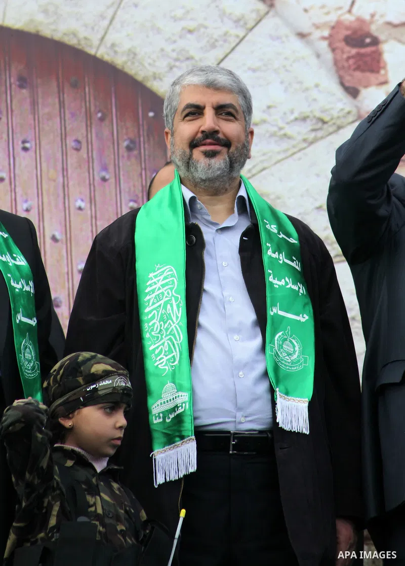 Hamas chief Khaled Meshaal, with senior Hamas leaders, takes part in a Hamas rally marking the 25th anniversary of the Islamist movement's founding in Gaza City on December 8, 2012. Meshaal arrived to Gaza strip on Decem...