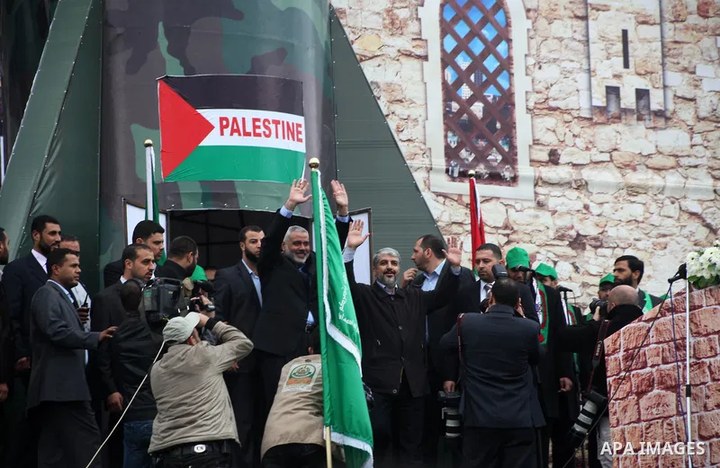 Hamas chief Khaled Meshaal, with senior Hamas leaders, takes part in a Hamas rally marking the 25th anniversary of the Islamist movement's founding in Gaza City on December 8, 2012. Meshaal arrived to Gaza strip on Decem...