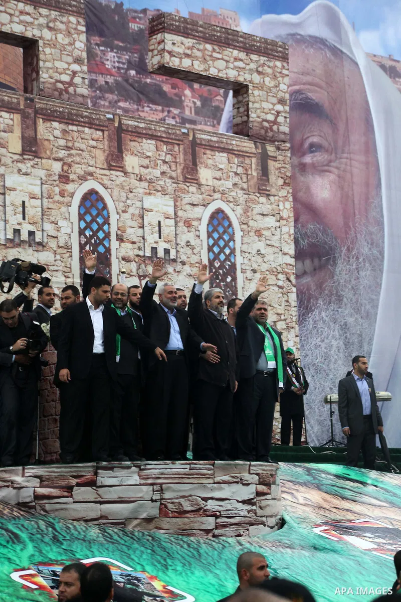 Hamas chief Khaled Meshaal, with senior Hamas leaders, takes part in a Hamas rally marking the 25th anniversary of the Islamist movement's founding in Gaza City on December 8, 2012. Meshaal arrived to Gaza strip on Decem...