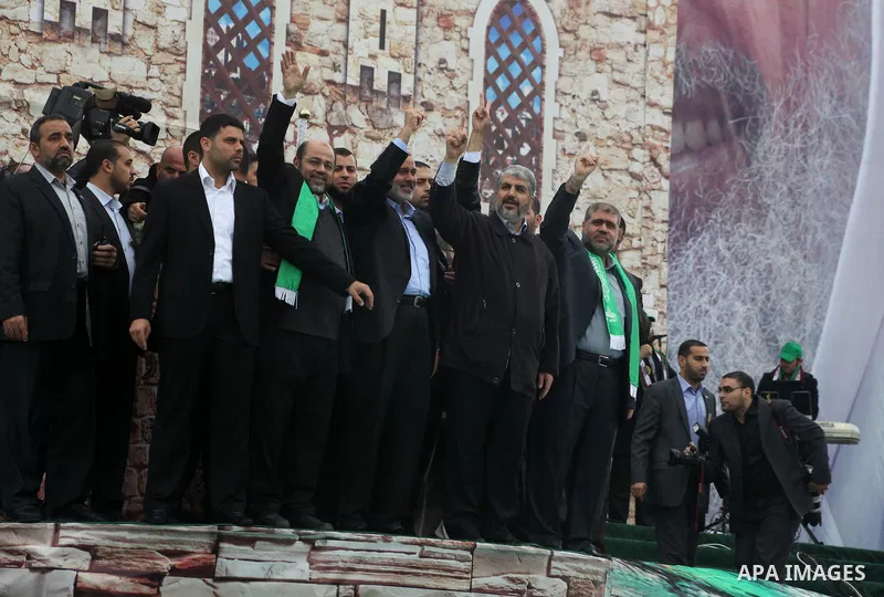Hamas chief Khaled Meshaal, with senior Hamas leaders, takes part in a Hamas rally marking the 25th anniversary of the Islamist movement's founding in Gaza City on December 8, 2012. Meshaal arrived to Gaza strip on Decem...