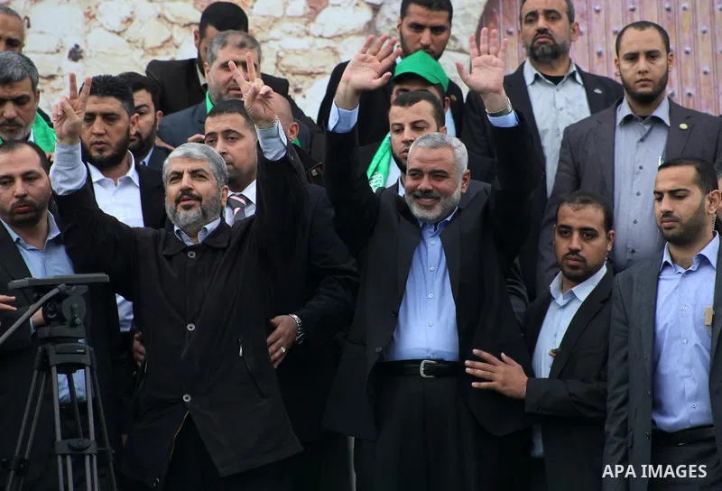 Hamas chief Khaled Meshaal, with senior Hamas leaders, takes part in a Hamas rally marking the 25th anniversary of the Islamist movement's founding in Gaza City on December 8, 2012. Meshaal arrived to Gaza strip on Decem...