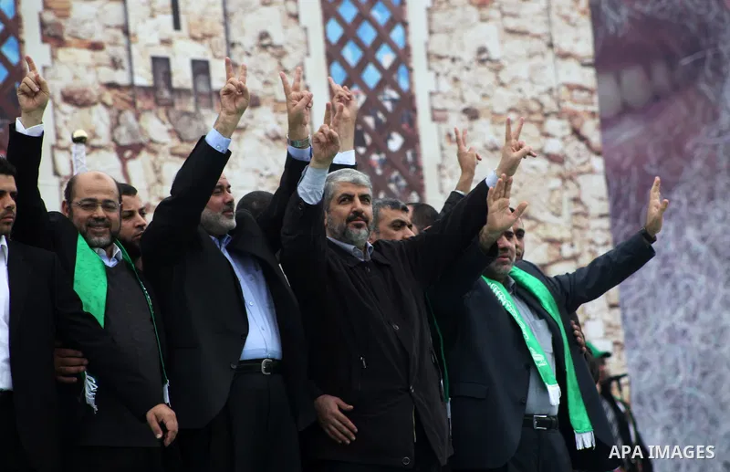 Hamas chief Khaled Meshaal, with senior Hamas leaders, takes part in a Hamas rally marking the 25th anniversary of the Islamist movement's founding in Gaza City on December 8, 2012. Meshaal arrived to Gaza strip on Decem...
