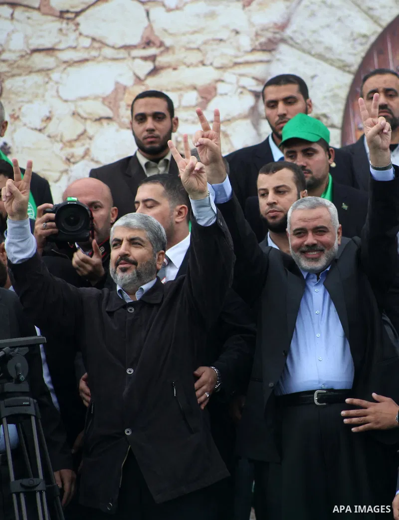 Hamas chief Khaled Meshaal, with senior Hamas leaders, takes part in a Hamas rally marking the 25th anniversary of the Islamist movement's founding in Gaza City on December 8, 2012. Meshaal arrived to Gaza strip on Decem...