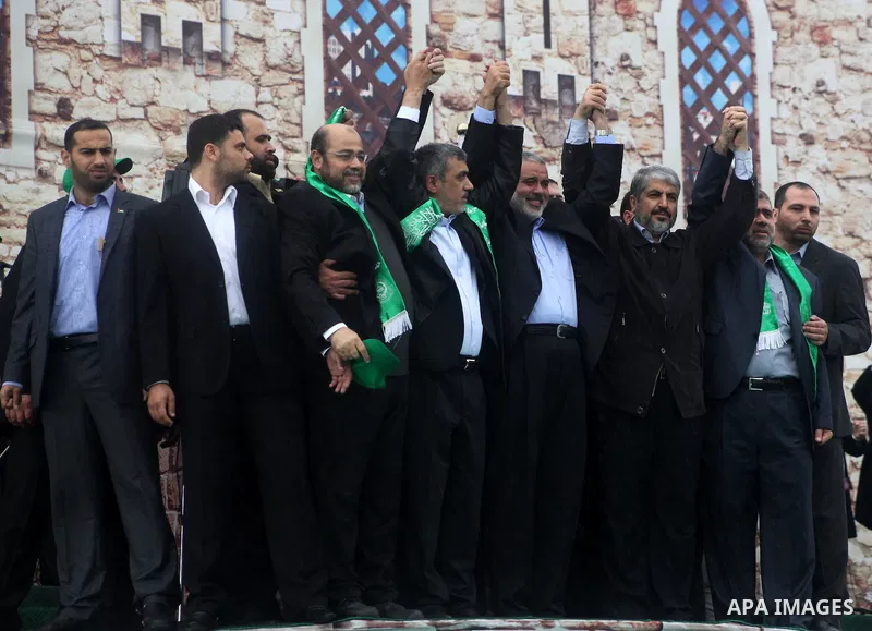 Hamas chief Khaled Meshaal, with senior Hamas leaders, takes part in a Hamas rally marking the 25th anniversary of the Islamist movement's founding in Gaza City on December 8, 2012. Meshaal arrived to Gaza strip on Decem...