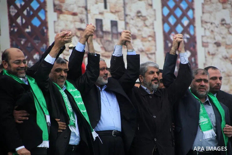 Hamas chief Khaled Meshaal, with senior Hamas leaders, takes part in a Hamas rally marking the 25th anniversary of the Islamist movement's founding in Gaza City on December 8, 2012. Meshaal arrived to Gaza strip on Decem...