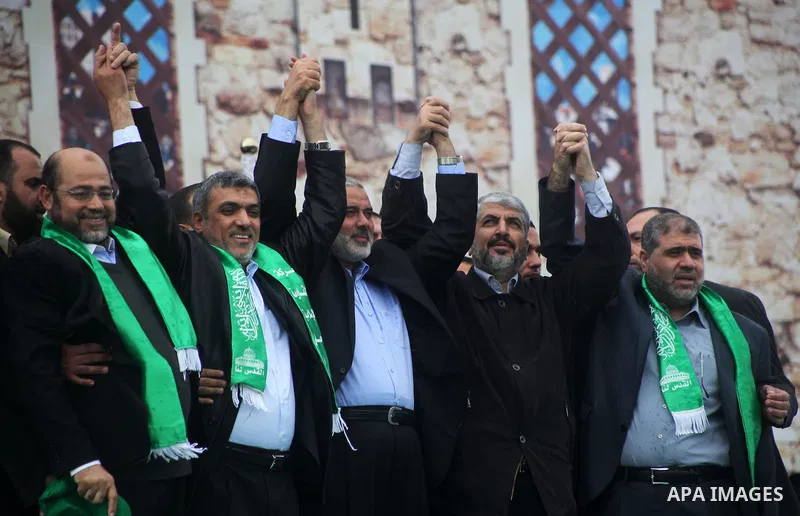 Hamas chief Khaled Meshaal, with senior Hamas leaders, takes part in a Hamas rally marking the 25th anniversary of the Islamist movement's founding in Gaza City on December 8, 2012. Meshaal arrived to Gaza strip on Decem...
