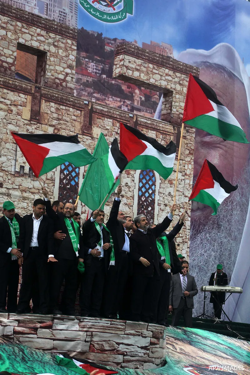 Hamas chief Khaled Meshaal, with senior Hamas leaders, takes part in a Hamas rally marking the 25th anniversary of the Islamist movement's founding in Gaza City on December 8, 2012. Meshaal arrived to Gaza strip on Decem...