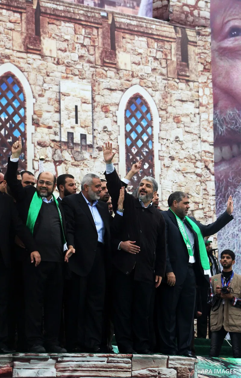 Hamas chief Khaled Meshaal, with senior Hamas leaders, takes part in a Hamas rally marking the 25th anniversary of the Islamist movement's founding in Gaza City on December 8, 2012. Meshaal arrived to Gaza strip on Decem...