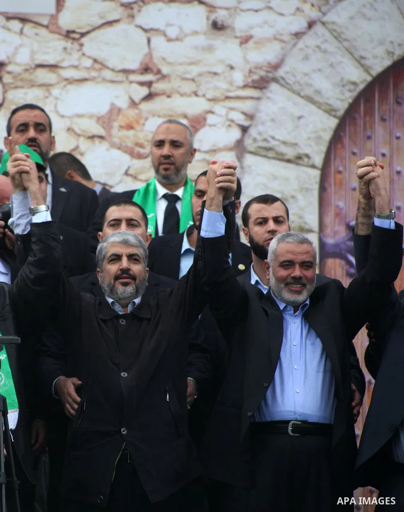 Hamas chief Khaled Meshaal, with senior Hamas leaders, takes part in a Hamas rally marking the 25th anniversary of the Islamist movement's founding in Gaza City on December 8, 2012. Meshaal arrived to Gaza strip on Decem...