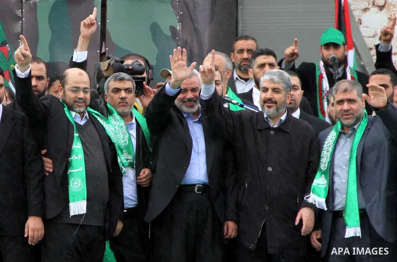 Hamas chief Khaled Meshaal, with senior Hamas leaders, takes part in a Hamas rally marking the 25th anniversary of the Islamist movement's founding in Gaza City on December 8, 2012. Meshaal arrived to Gaza strip on Decem...