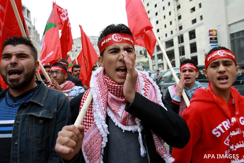Supporters of the Popular Front for the Liberation of Palestine (PFLP) carry the party flag during a rally to mark the 45th anniversary of the establishment of the PFLP in the West Bank city of Nablus on December 8, 2012...