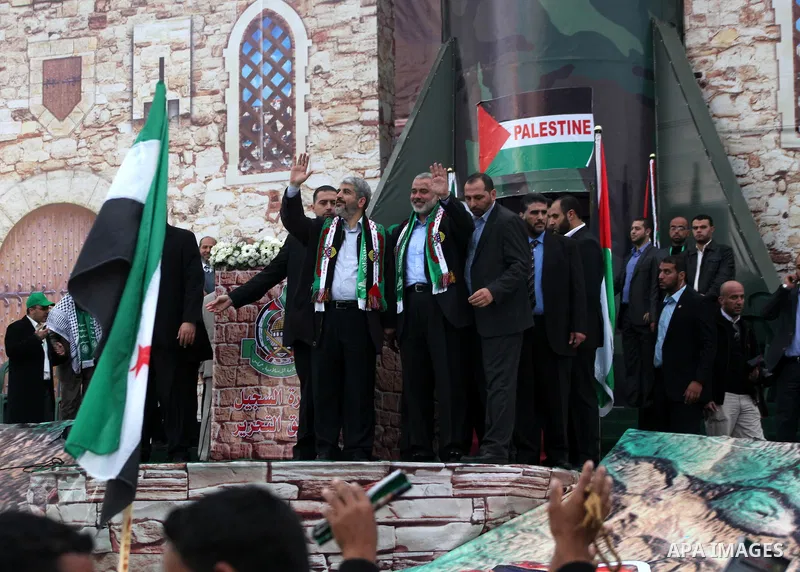 Hamas chief Khaled Meshaal, with senior Hamas leaders, takes part in a Hamas rally marking the 25th anniversary of the Islamist movement's founding in Gaza City on December 8, 2012. Meshaal arrived to Gaza strip on Decem...