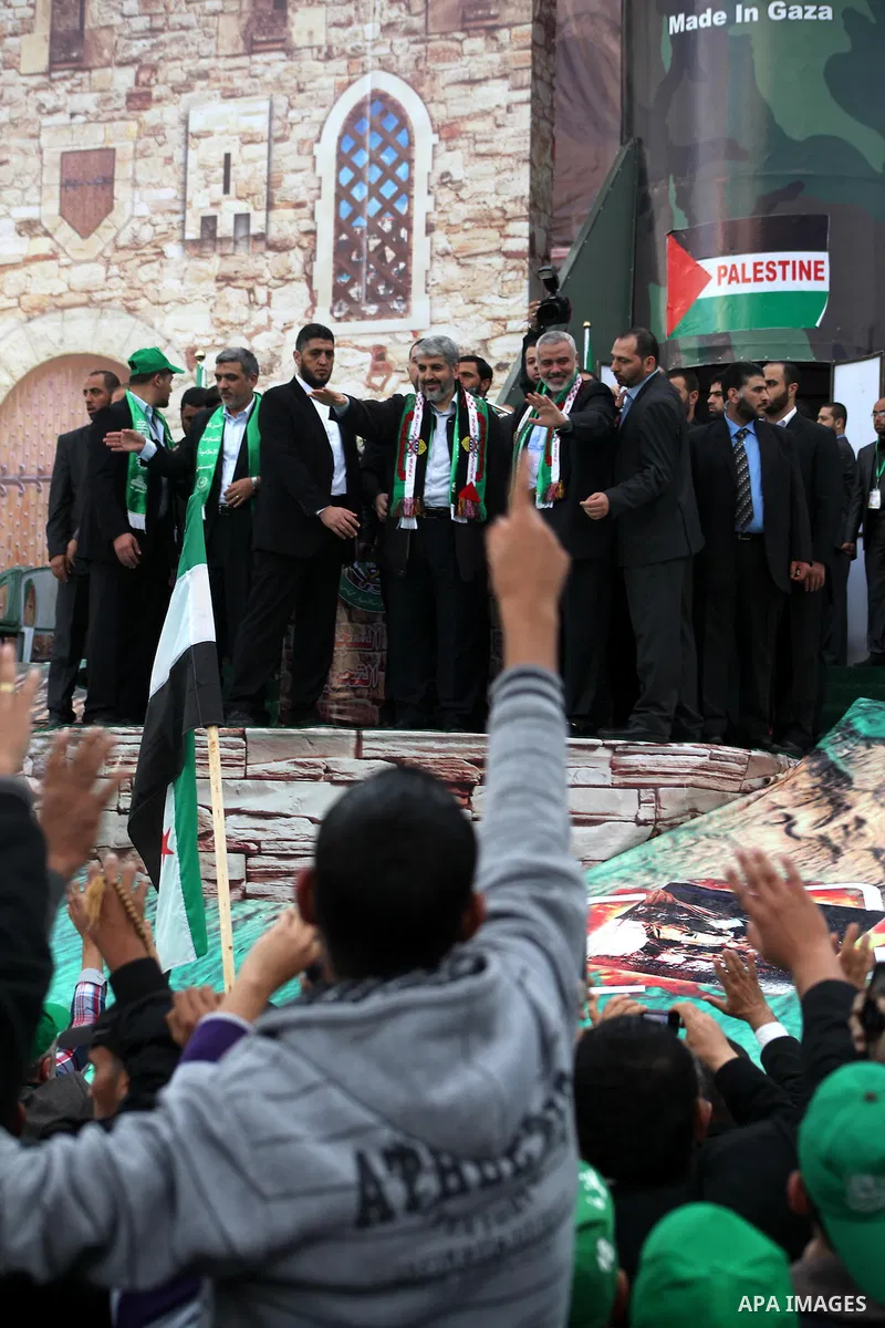 Hamas chief Khaled Meshaal, with senior Hamas leaders, takes part in a Hamas rally marking the 25th anniversary of the Islamist movement's founding in Gaza City on December 8, 2012. Meshaal arrived to Gaza strip on Decem...