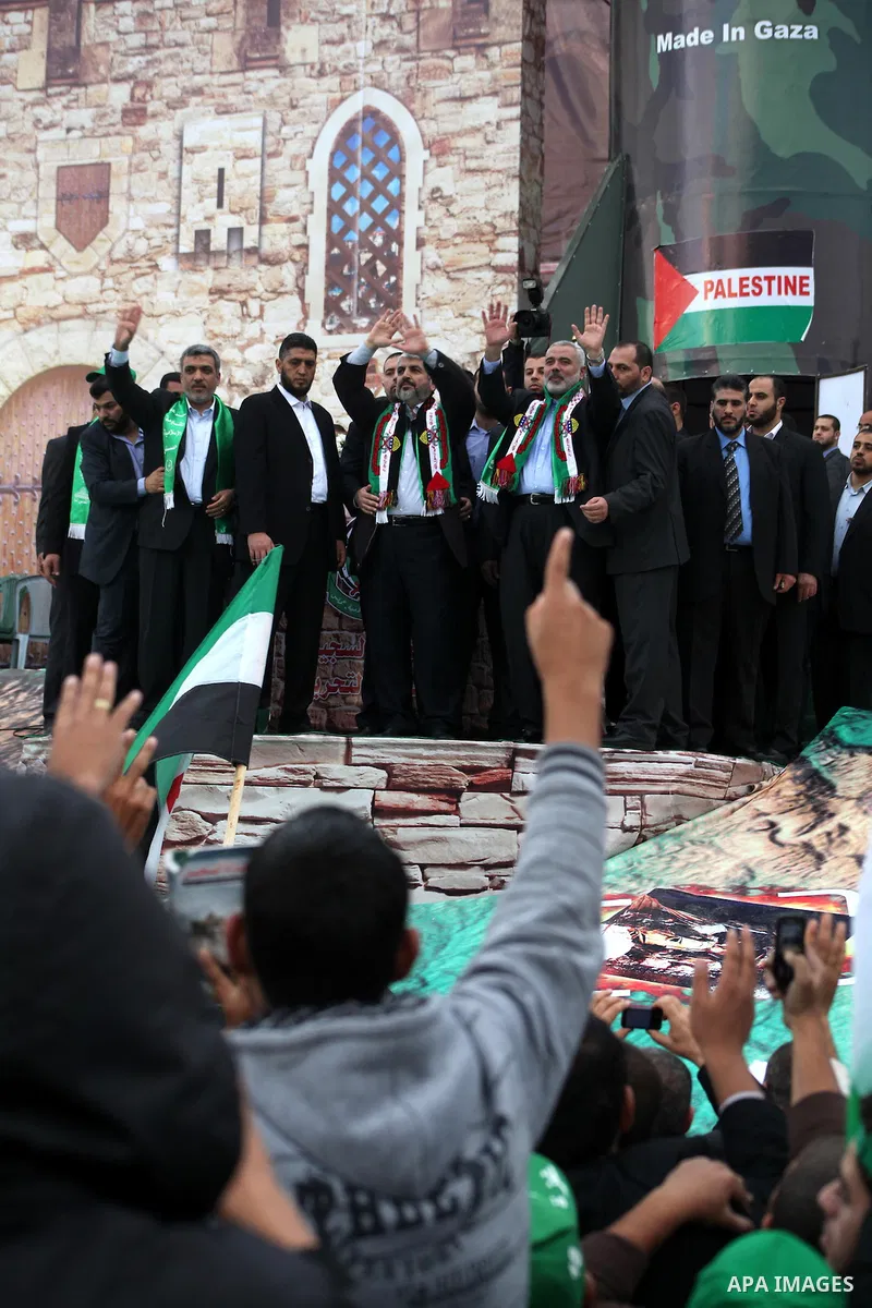 Hamas chief Khaled Meshaal, with senior Hamas leaders, takes part in a Hamas rally marking the 25th anniversary of the Islamist movement's founding in Gaza City on December 8, 2012. Meshaal arrived to Gaza strip on Decem...