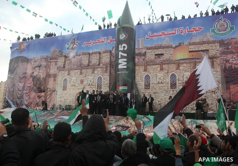 Hamas chief Khaled Meshaal, with senior Hamas leaders, takes part in a Hamas rally marking the 25th anniversary of the Islamist movement's founding in Gaza City on December 8, 2012. Meshaal arrived to Gaza strip on Decem...