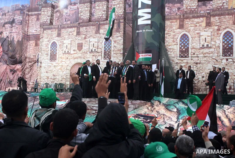 Hamas chief Khaled Meshaal, with senior Hamas leaders, takes part in a Hamas rally marking the 25th anniversary of the Islamist movement's founding in Gaza City on December 8, 2012. Meshaal arrived to Gaza strip on Decem...