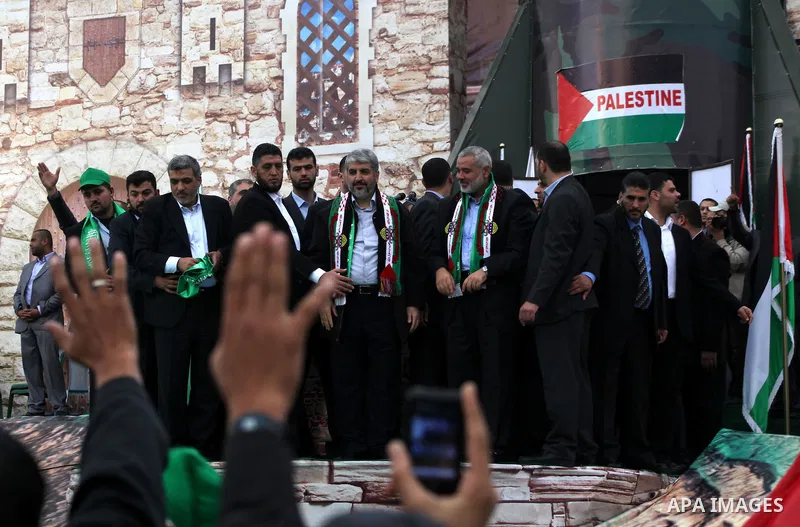 Hamas chief Khaled Meshaal, with senior Hamas leaders, takes part in a Hamas rally marking the 25th anniversary of the Islamist movement's founding in Gaza City on December 8, 2012. Meshaal arrived to Gaza strip on Decem...
