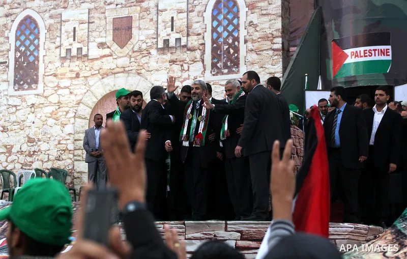 Hamas chief Khaled Meshaal, with senior Hamas leaders, takes part in a Hamas rally marking the 25th anniversary of the Islamist movement's founding in Gaza City on December 8, 2012. Meshaal arrived to Gaza strip on Decem...