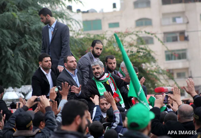 Hamas chief Khaled Meshaal, with senior Hamas leaders, takes part in a Hamas rally marking the 25th anniversary of the Islamist movement's founding in Gaza City on December 8, 2012. Meshaal arrived to Gaza strip on Decem...