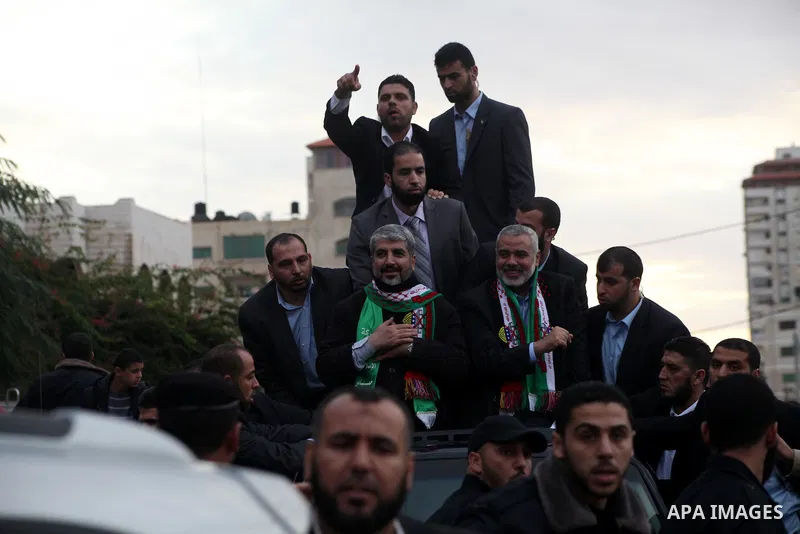 Hamas chief Khaled Meshaal, with senior Hamas leaders, takes part in a Hamas rally marking the 25th anniversary of the Islamist movement's founding in Gaza City on December 8, 2012. Meshaal arrived to Gaza strip on Decem...