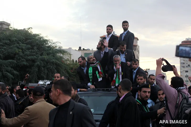 Hamas chief Khaled Meshaal, with senior Hamas leaders, takes part in a Hamas rally marking the 25th anniversary of the Islamist movement's founding in Gaza City on December 8, 2012. Meshaal arrived to Gaza strip on Decem...