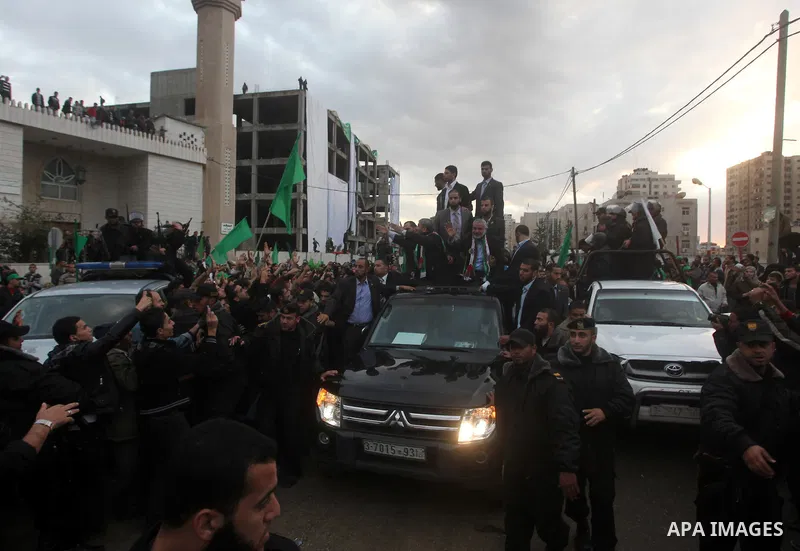 Hamas chief Khaled Meshaal, with senior Hamas leaders, takes part in a Hamas rally marking the 25th anniversary of the Islamist movement's founding in Gaza City on December 8, 2012. Meshaal arrived to Gaza strip on Decem...