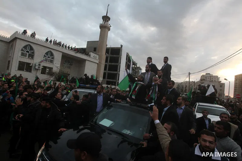 Hamas chief Khaled Meshaal, with senior Hamas leaders, takes part in a Hamas rally marking the 25th anniversary of the Islamist movement's founding in Gaza City on December 8, 2012. Meshaal arrived to Gaza strip on Decem...