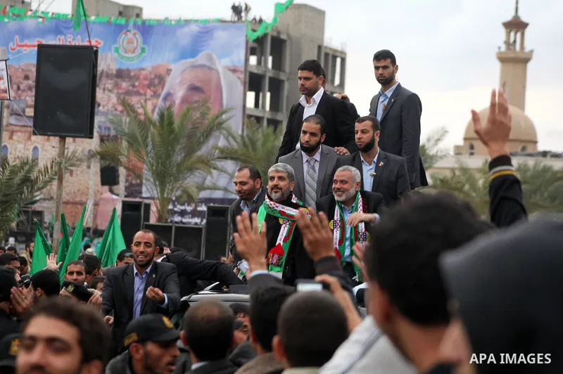 Hamas chief Khaled Meshaal, with senior Hamas leaders, takes part in a Hamas rally marking the 25th anniversary of the Islamist movement's founding in Gaza City on December 8, 2012. Meshaal arrived to Gaza strip on Decem...