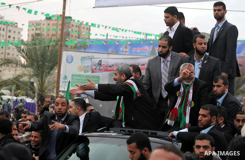Hamas chief Khaled Meshaal, with senior Hamas leaders, takes part in a Hamas rally marking the 25th anniversary of the Islamist movement's founding in Gaza City on December 8, 2012. Meshaal arrived to Gaza strip on Decem...