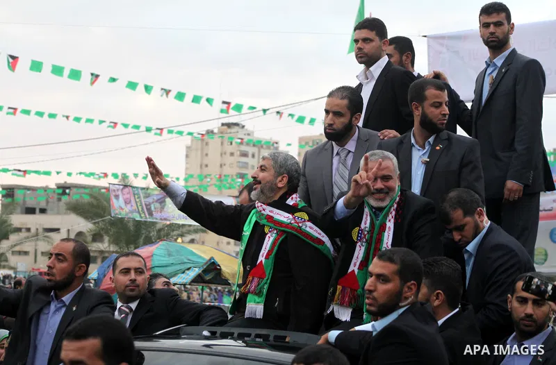 Hamas chief Khaled Meshaal, with senior Hamas leaders, takes part in a Hamas rally marking the 25th anniversary of the Islamist movement's founding in Gaza City on December 8, 2012. Meshaal arrived to Gaza strip on Decem...