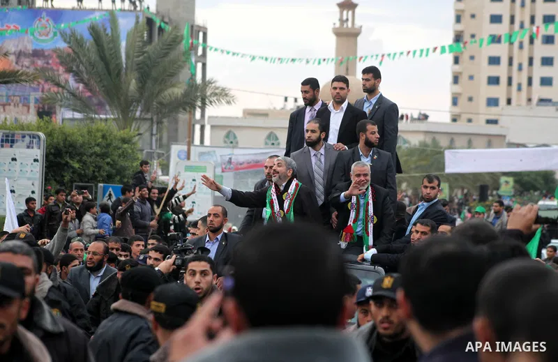 Hamas chief Khaled Meshaal, with senior Hamas leaders, takes part in a Hamas rally marking the 25th anniversary of the Islamist movement's founding in Gaza City on December 8, 2012. Meshaal arrived to Gaza strip on Decem...