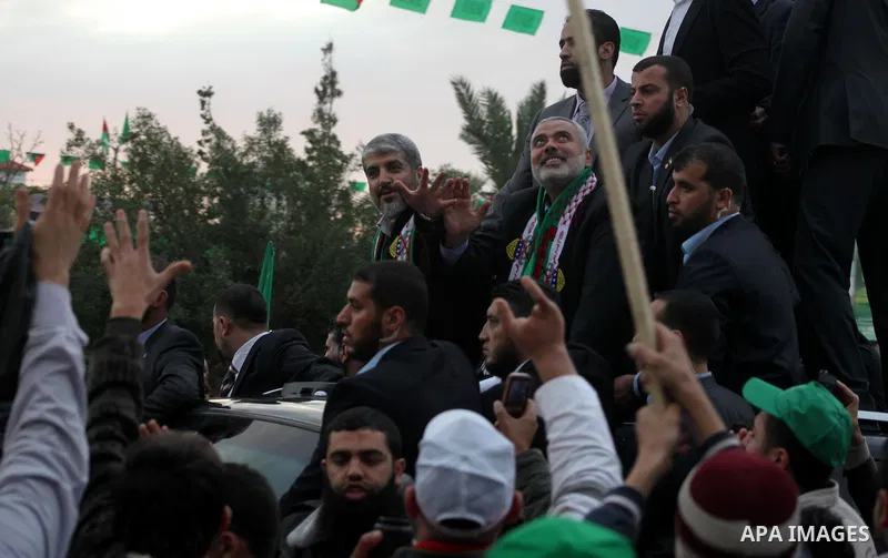 Hamas chief Khaled Meshaal, with senior Hamas leaders, takes part in a Hamas rally marking the 25th anniversary of the Islamist movement's founding in Gaza City on December 8, 2012. Meshaal arrived to Gaza strip on Decem...