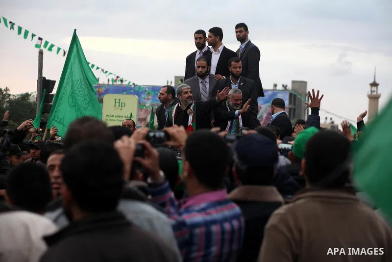 Hamas chief Khaled Meshaal, with senior Hamas leaders, takes part in a Hamas rally marking the 25th anniversary of the Islamist movement's founding in Gaza City on December 8, 2012. Meshaal arrived to Gaza strip on Decem...