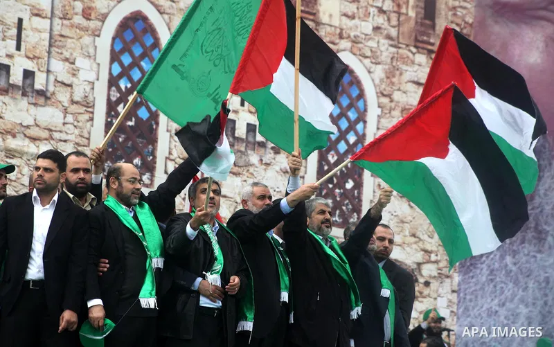 Hamas chief Khaled Meshaal, with senior Hamas leaders, takes part in a Hamas rally marking the 25th anniversary of the Islamist movement's founding in Gaza City on December 8, 2012. Meshaal arrived to Gaza strip on Decem...